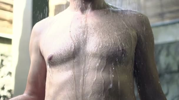Man taking bath under shower — Stockvideo