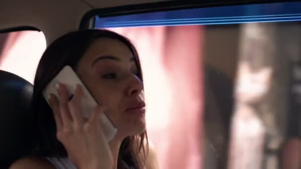 Vacker kvinna talar i mobiltelefon i bilen — Stockvideo