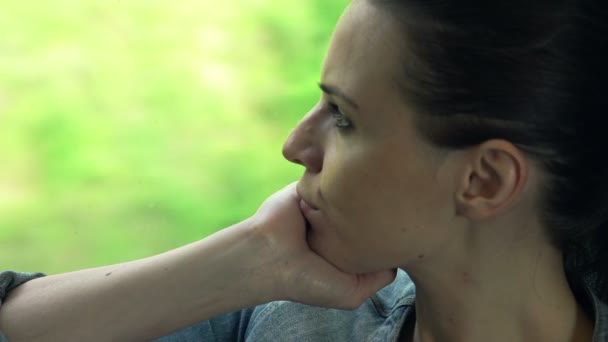 Donna che guarda attraverso la finestra durante il viaggio in treno — Video Stock