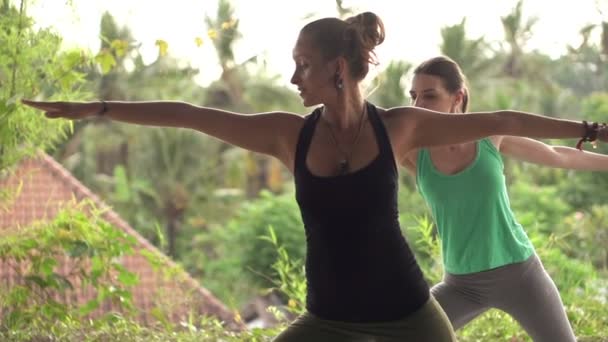 Girlfriends on terrace exercising yoga — Stock Video