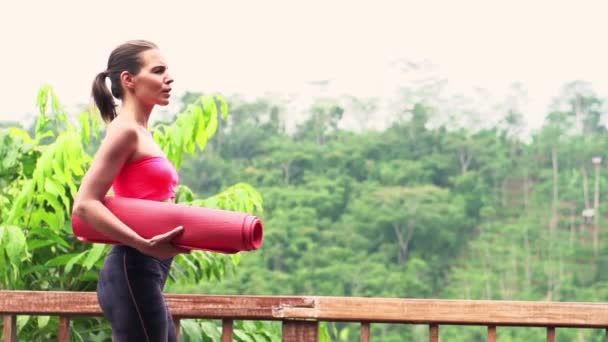 Woman unfold mat on terrace — Stock Footage Woman unfold mat on terrace Stock Video