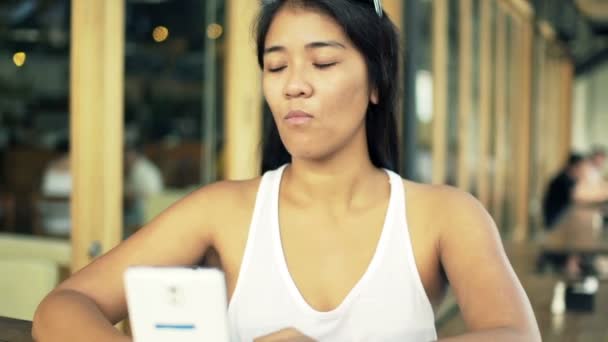 Sad woman with smartphone waiting for someone — Stock Video