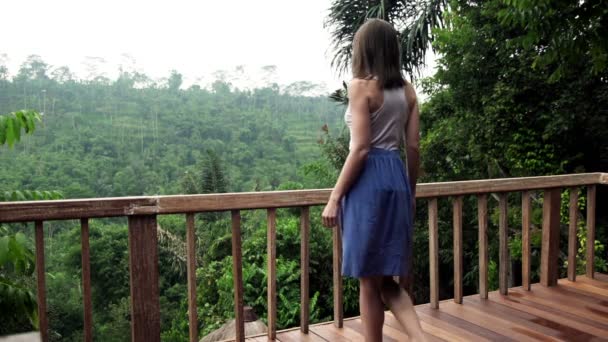 Woman walking out on terrace — Stock Video