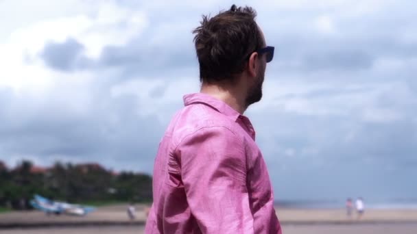 Young man on beach — Stock Video