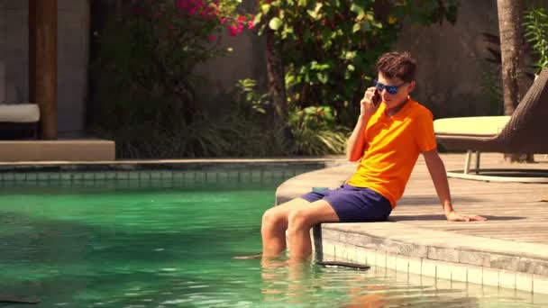 Ragazzo parlando sul cellulare in piscina — Video Stock