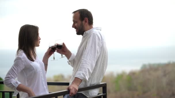 Couple raising toast, celebrating on terrace — Stock Video