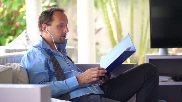 Hombre de negocios teniendo una conversación telefónica con auriculares — Vídeo de stock