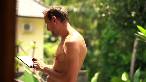 Man using tablet computer on terrace — Stock Video