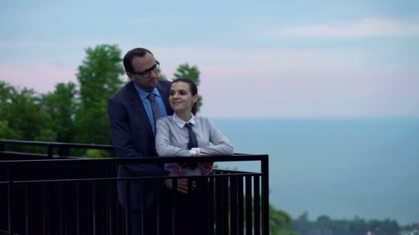 Happy business couple standing on terrace — Stock Video