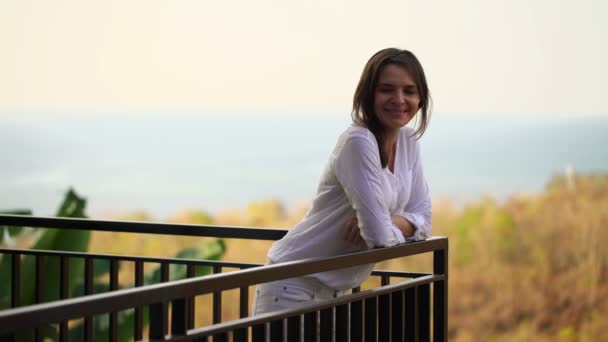 Beautiful woman standing on terrace — Stock Video