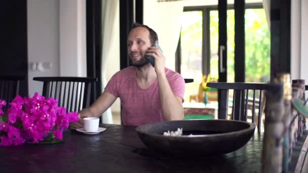 Man talking on cellphone and drinking coffee — Stock Video