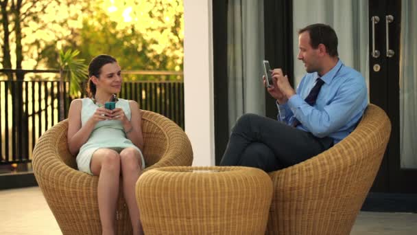 Businessman taking photo of businesswoman on terrace — Stock Video