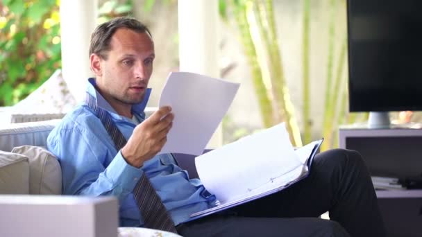 Businessman overwhelmed by bad news in documents — Stock Video