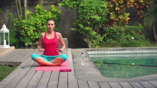 Woman doing breathing exercise sitting on mat — Stock Video
