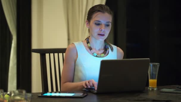 Businesswoman with laptop having break and drinking cocktail — Stock Video