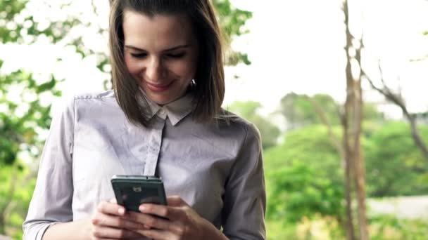 Mujer de negocios con smartphone stadning en la terraza — Vídeos de Stock