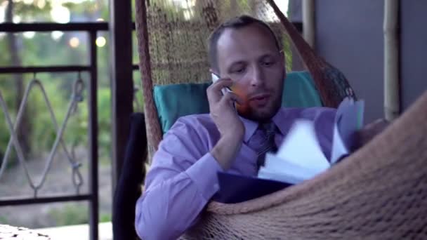携帯電話で話しドキュメントを持ったビジネスマン — ストック動画