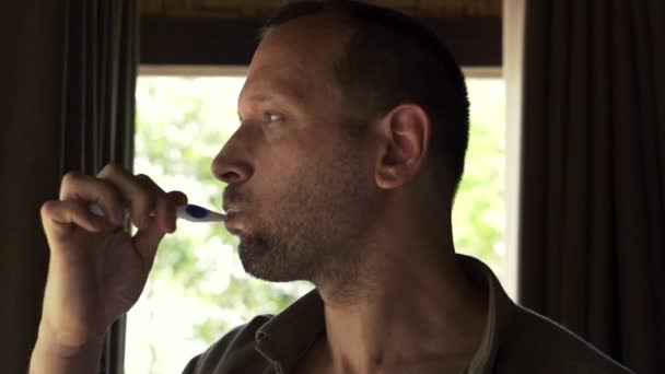 Young man brushing his teeth — Stock Video