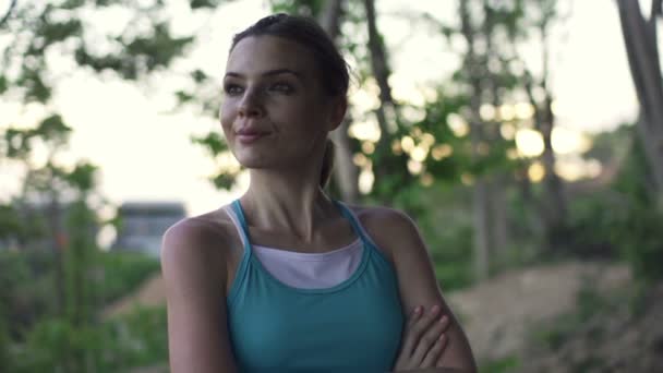 Pensive young woman standing in park — Stock Video