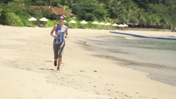 Sexy woman running on beautiful beach — Stock Video