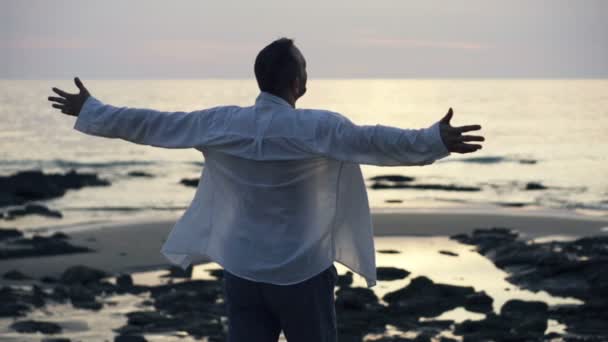 Excited man turning round by the sea — Stock Video