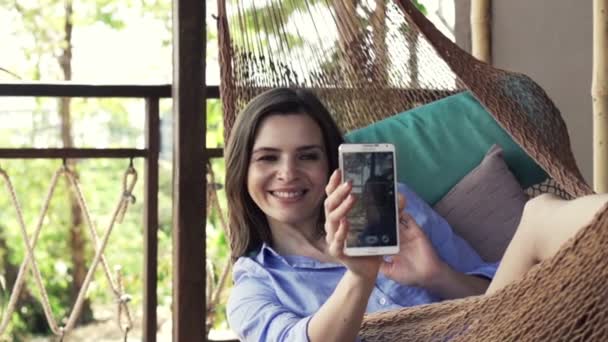 Frau macht Selfie-Foto mit Handy in Hängematte — Stockvideo