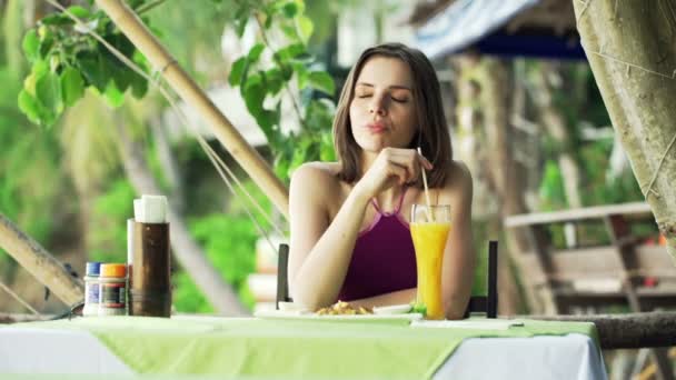 Woman drinking juice sitting in cafe — Stock Video