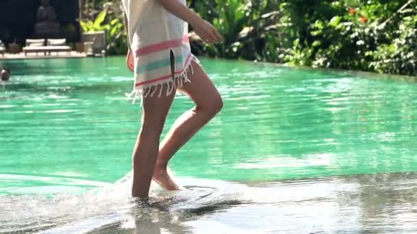 Woman legs walking on edge of swimming pool — Stock Video