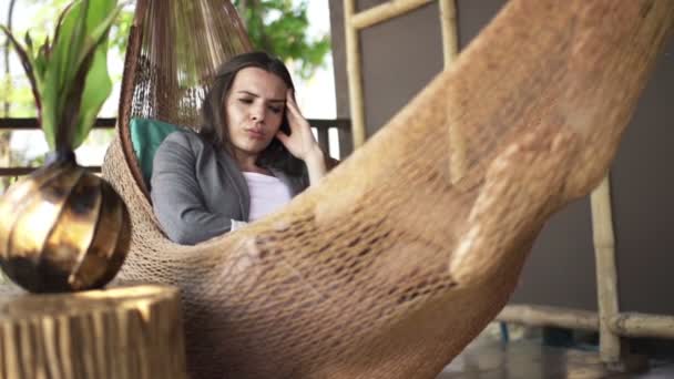 Tired businesswoman having headache on hammock — Stock Video