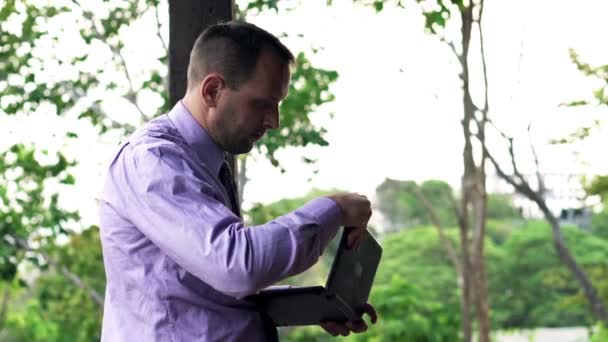 Businessman using modern laptop on terrace — Stock Video