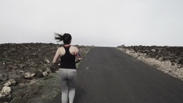 Femme jogging jusqu'à travers la route — Video