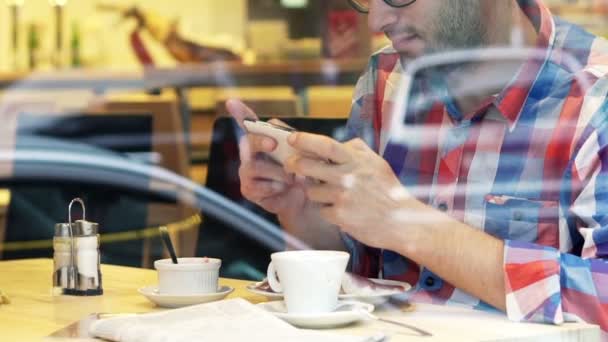 Hombre guapo jugando juego en el teléfono inteligente — Vídeos de Stock