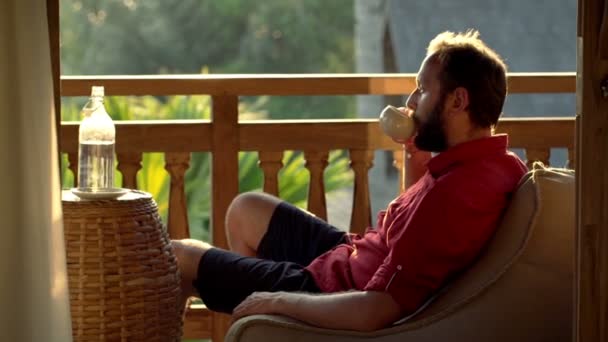 Man drinking coffee and relaxing on terrace — Stock Video