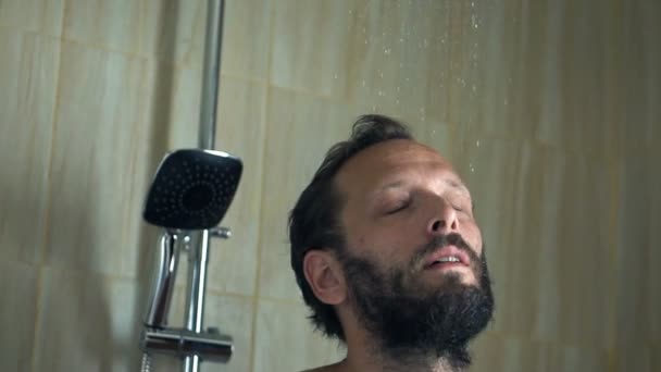 Man washing his hair under shower — Stockvideo