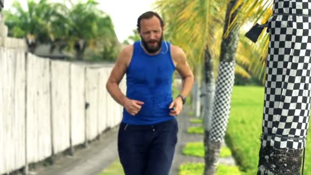 Uomo che fa jogging e controlla il polso su smartwatch — Video Stock