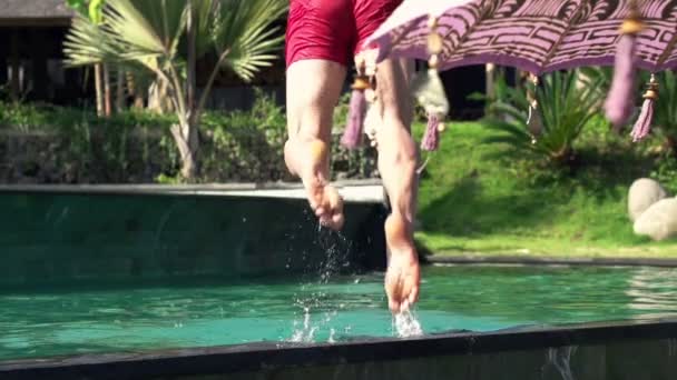 Young man jumping to swimming pool — Stock Video