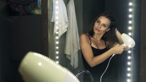 Pretty woman drying her hair in bathroom — Stock Video