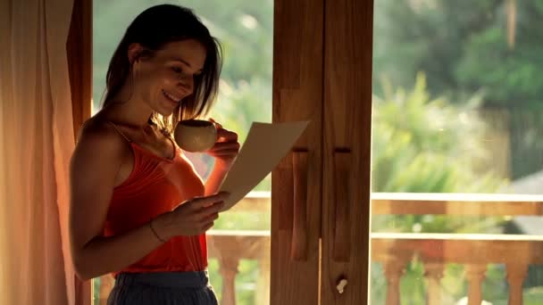 Mujer leyendo carta y bebiendo café — Vídeos de Stock