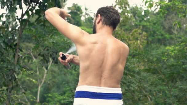 Man applying anti-perspirant on armpit on terrace — Stock Video