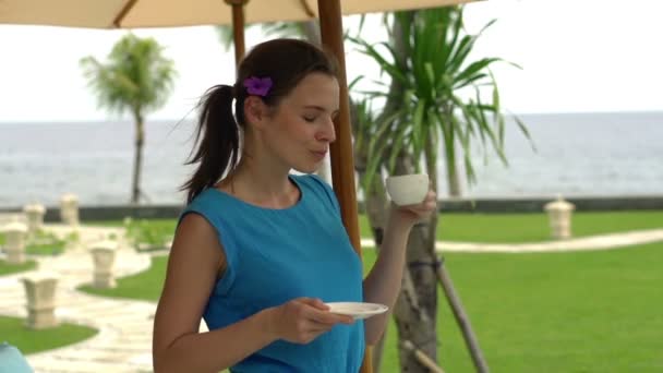 Woman drinking coffee in the garden — Stock Video