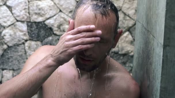 Depressed man under shower — Stock Video