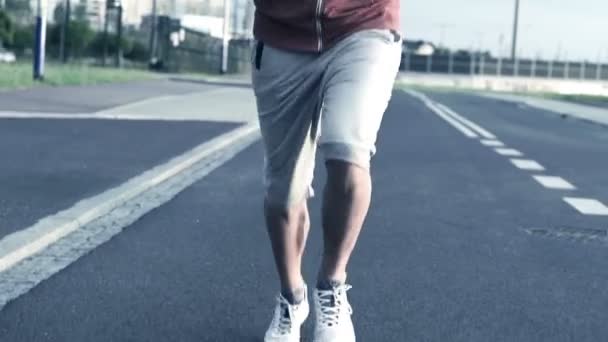 Jogger running on asphalt road — Stock Video