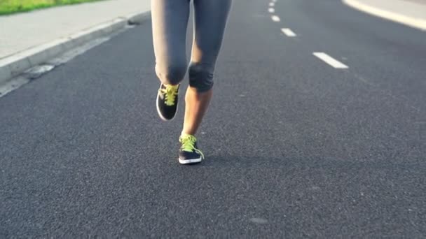 Woman running on asphalt road — Stock Video