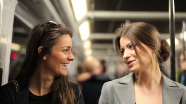 Happy girlfriends chatting during metro ride — Stock Video