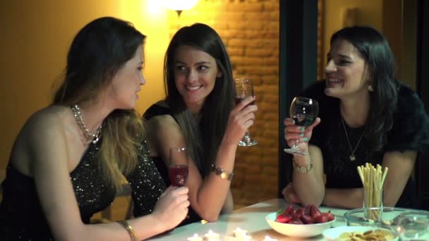 Elegant girlfriends chatting by the table at night party, slow motion — Stock Video