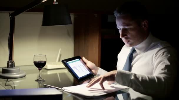 Contabilista trabalhando com tablet computador e documentos tarde da noite — Vídeo de Stock