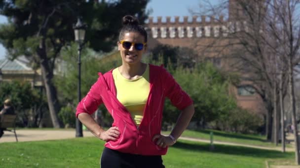 Young happy female jogger in the park — Stock Video