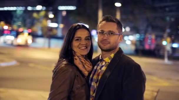 Happy young couple in love standing in the night by the street — Stock Video