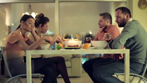 Unhappy, bored friends sitting by the table on bad double date — Stock Video