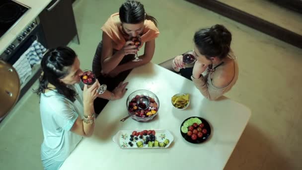 Three girlfriends raising toast, talking, laughing at home party — Stock Video